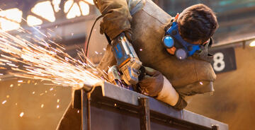 Man wearing safety gear welding